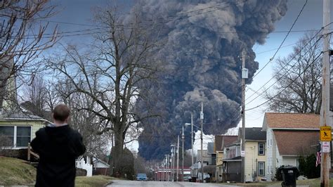 An Ohio state trooper goes door to door telling residents to leave downtown East Palestine, Ohio, on Sunday, Feb. 5, 2023. A smoldering tangle of dozens of derailed freight cars, some carrying hazardous materials, has kept an evacuation order in effect in Ohio near the Pennsylvania state line as environmental authorities warily watch air …
